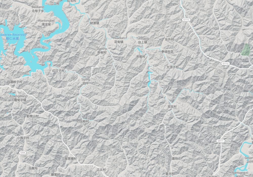 Ji'an is in the south-east beside the Yalu River; Huanren lies to the north-west; hillshade and 100 m contours